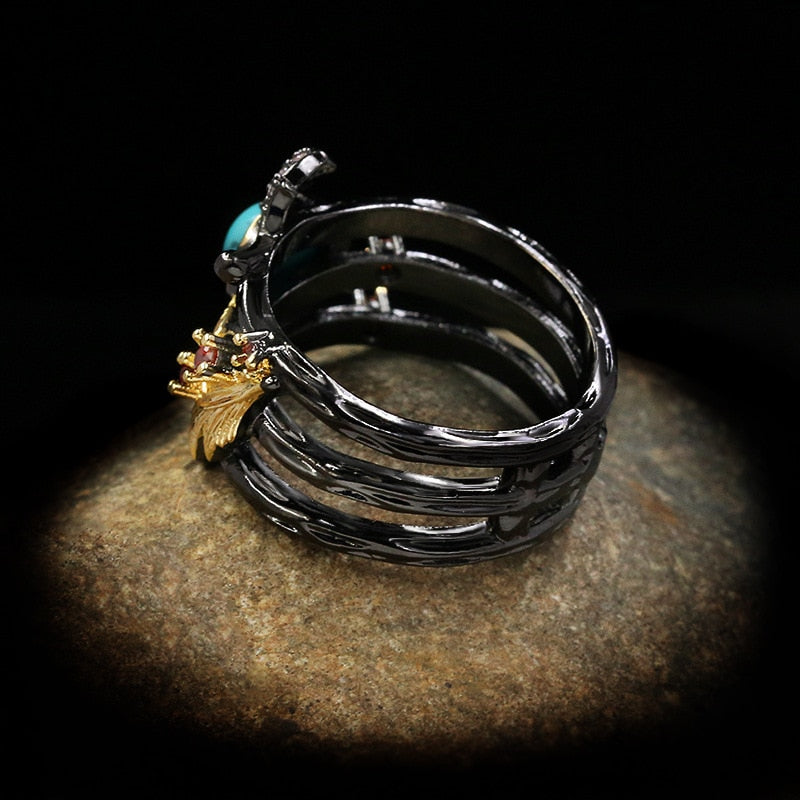Gouden veder ring met blauwe siersteen