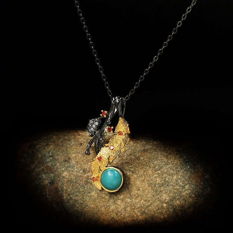 Gouden veder halsketting met blauwe siersteen