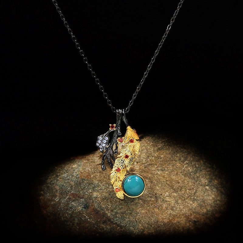 Gouden veder halsketting met blauwe siersteen