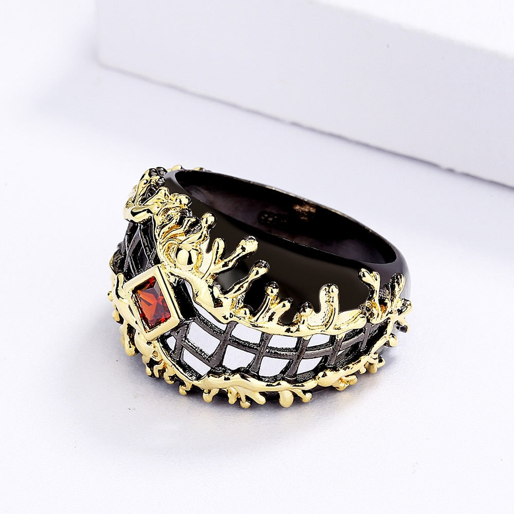 Gewoven zwart-gouden ring met rode siersteen