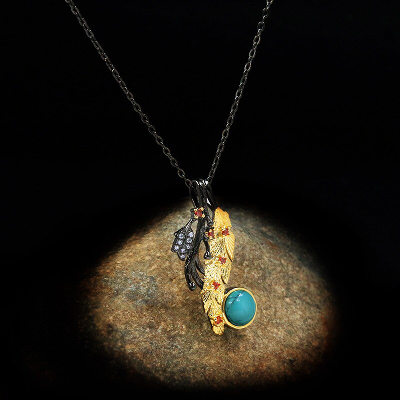 Gouden veder halsketting met blauwe siersteen