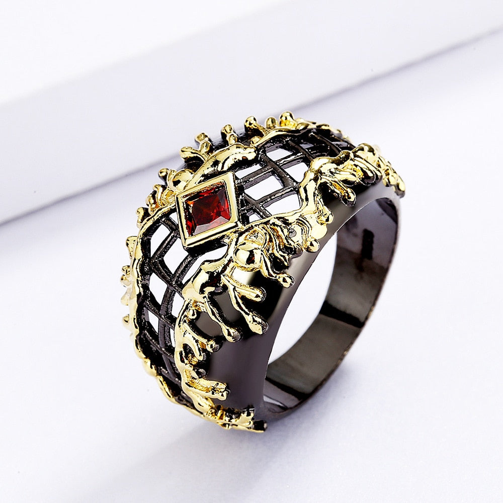 Gewoven zwart-gouden ring met rode siersteen